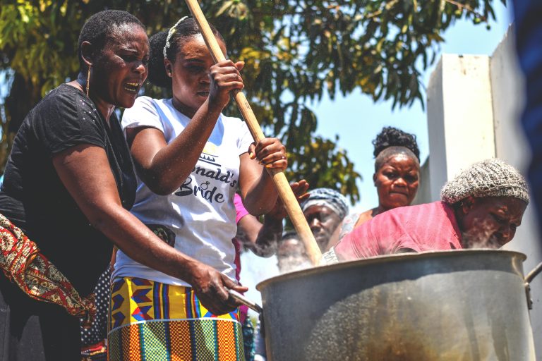 Women Cooking Outdoors in a Huge Pot