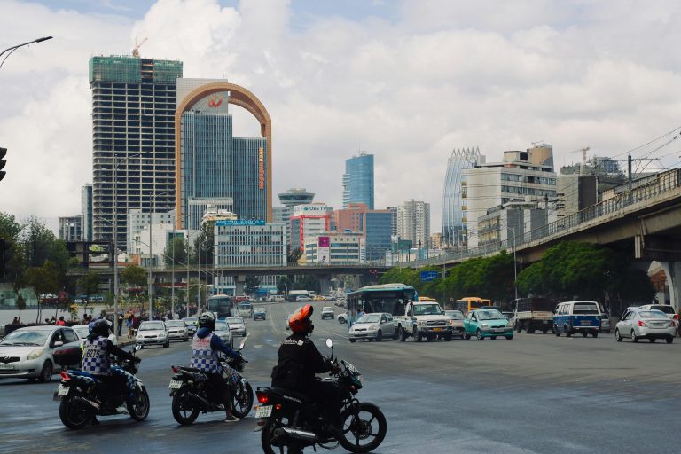 People in Black Motorcycle on Road