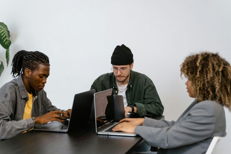 Colleagues Busy Using Their Laptops