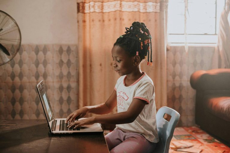 A young girl using a laptop